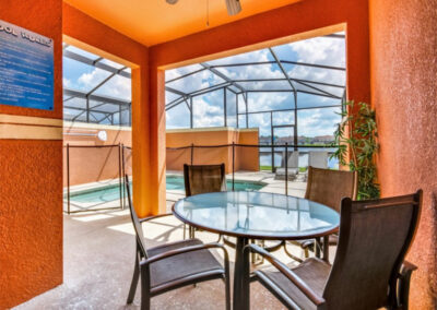 The covered lanai, alfresco dining area & swimming pool at Paradise Palms Resort 10, Kissimmee